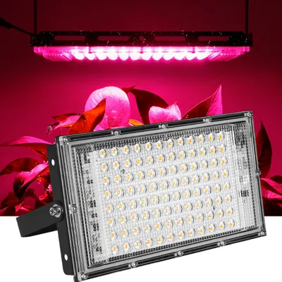 A grow light is shown in the foreground, with plants and another grow light in the background.