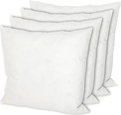 A stack of four white pillows arranged diagonally.