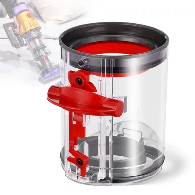 A transparent dust container with red and black components, with a blurred vacuum cleaner in the background.