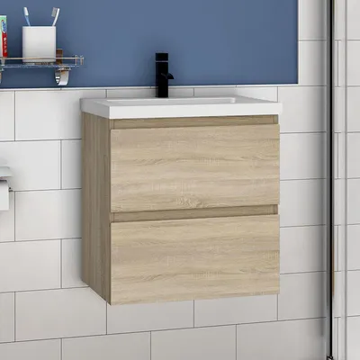 A bathroom vanity with a sink and faucet against a tiled wall and blue background.