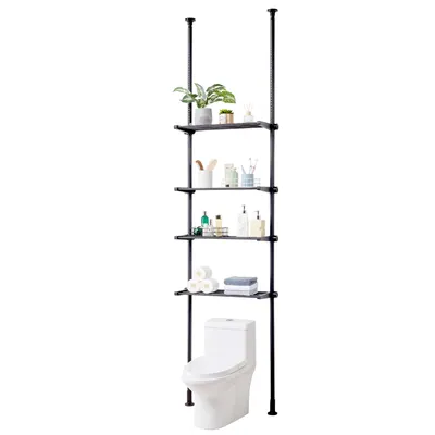 A black, four-tier storage shelf unit is positioned over a white toilet. The shelves contain various bathroom items, including plants, toiletries, and rolls of toilet paper.