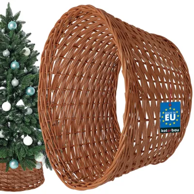 A Christmas tree with ornaments and a wicker tree skirt.