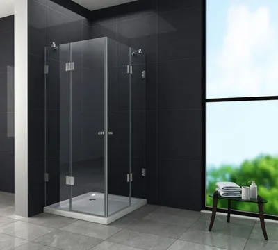 A modern bathroom with a glass shower enclosure, dark tiled walls, and a large window overlooking greenery.