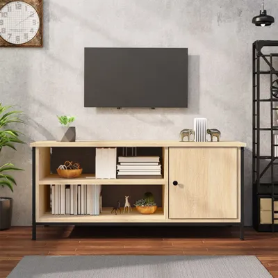 A TV stand with a TV mounted above it, in a room with a concrete wall and wooden floor.
