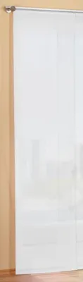 A white sheer curtain hanging on a rod against a light beige wall.