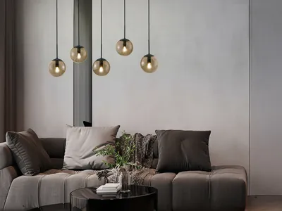 A modern living room with a sectional sofa and a multi-pendant light fixture.