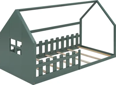A green wooden house-shaped bed frame with a fence-like railing and a window cutout, shown from a three-quarter angle against a white background.