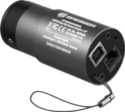 The back of a cylindrical electronic device, likely a camera or sensor, with various ports and labels.