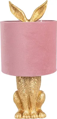 A table lamp with a pink velvet shade and a gold rabbit base.