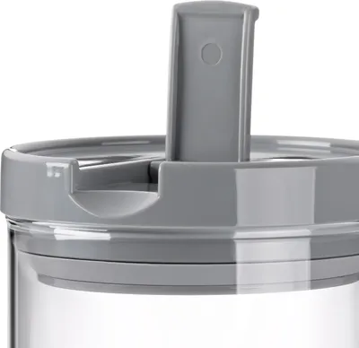 A close-up view of the lid of a clear storage container with a gray lid and a gray flip-up spout.