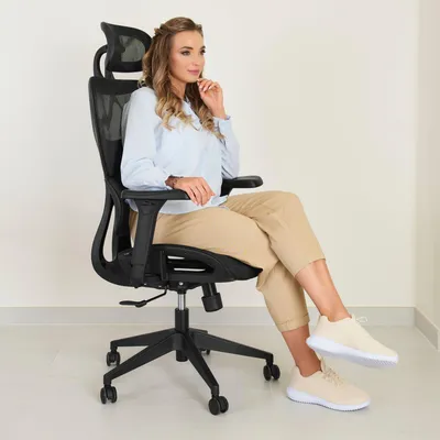 A woman is sitting in an office chair.