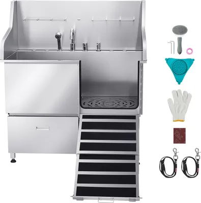 A stainless steel pet grooming tub with a ramp and various accessories displayed to the right.