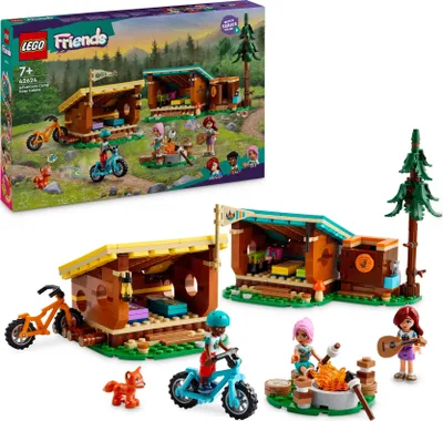 A LEGO Friends Gemütliche Hütten im Abenteuercamp playset is shown, both in its packaging and assembled. The packaging displays the set in a natural, outdoor setting with characters and accessories. The assembled set shows two small cabins, bicycles, a cam