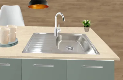 A kitchen sink with cups and a small plant on a countertop.