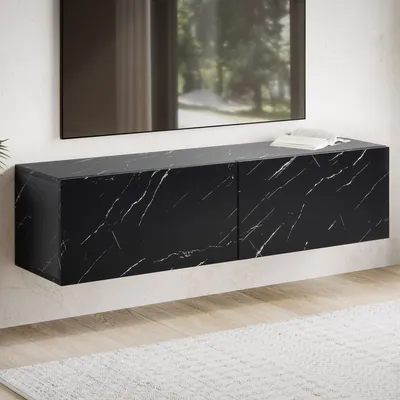 A black marble-look TV cabinet mounted on a white wall, with a rug and wooden floor visible below.