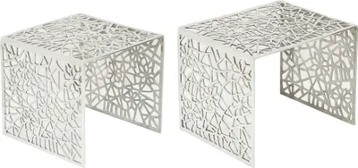 Two identical silver side tables with intricate cut-out patterns.