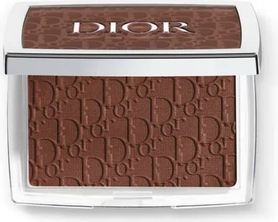 A close-up, top-down view of a Dior bronzer compact.