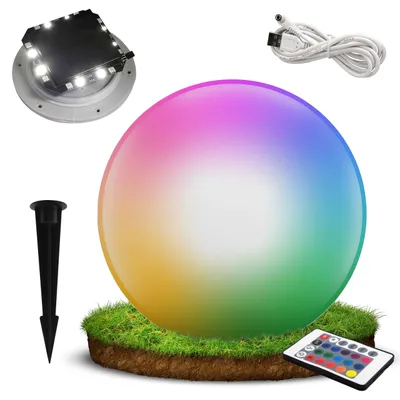 A collection of items for a solar-powered LED garden light, including the light itself, a stake, a USB cable, and a remote control, set against a white background with a small patch of grass and soil.