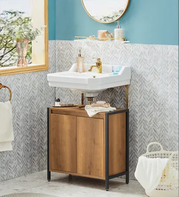 A bathroom vanity with a sink and cabinet, decorated with soap dispensers and a vase of flowers.
