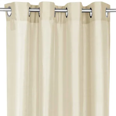 A close-up view of a beige curtain hanging from a curtain rod.