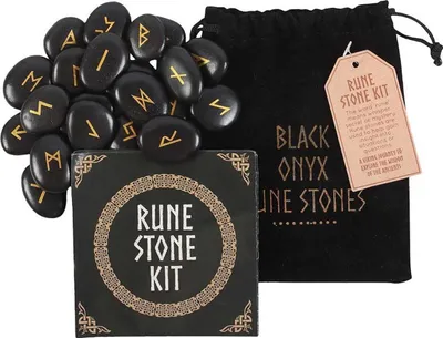 A set of black onyx rune stones with gold symbols, a black velvet pouch, and a small instruction booklet, arranged on a white background.