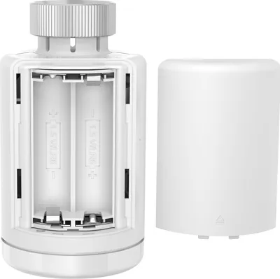 A white battery-powered device with its battery compartment open, showing two AAA batteries, and its cap removed and placed next to it.