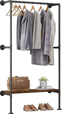 A clothing rack with clothes, a bag, a plant, and shoes.