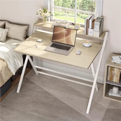 A bedroom or study area with a desk and bed.