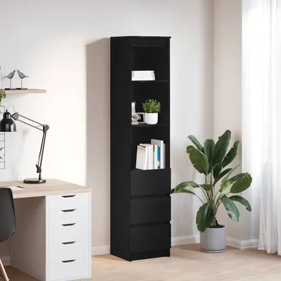 A tall, black bookshelf with drawers is shown next to a desk with a lamp and a potted plant.