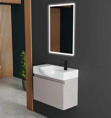 A modern bathroom vanity with a sink, faucet, and illuminated mirror.