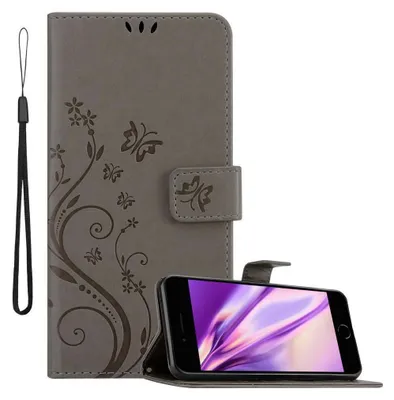 A grey flip phone case with a floral and butterfly design is shown, with a smartphone placed inside it.