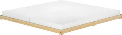 A low-profile wooden bed frame with two mattresses on a white background.
