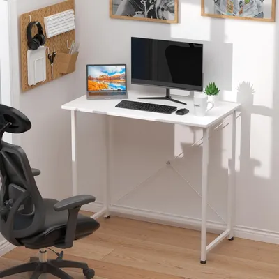 A white folding desk with a computer setup and a black office chair.