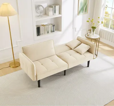 A beige sofa bed is shown in a living room setting.
