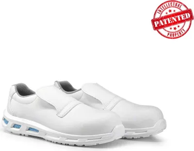 A pair of white safety slip-on shoes are displayed on a white background.