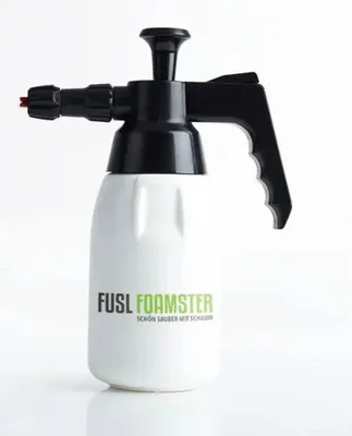A white foam sprayer with a black pump mechanism and handle, set against a white background.