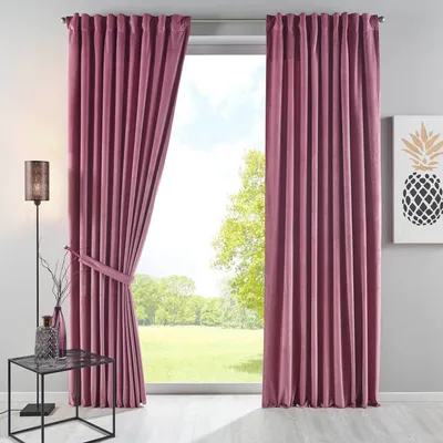 A room interior with a large window covered by pink velvet curtains.