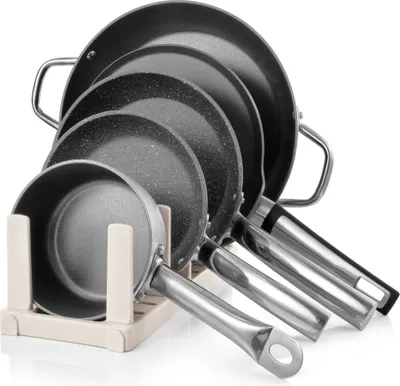 A set of pots and pans neatly arranged in a stand.