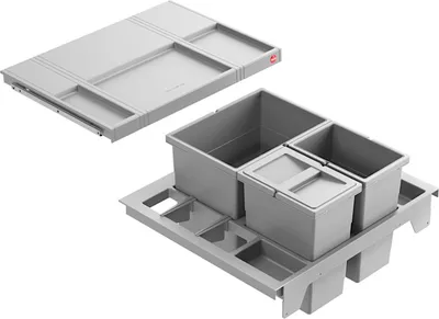 A gray kitchen waste sorting system with multiple bins and a sliding drawer organizer.
