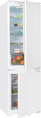 A white built-in refrigerator-freezer combination with its doors open, showing the interior compartments and food items.