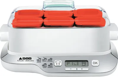 A white and gray yogurt maker with red yogurt pots inside, shown from a front-facing angle.