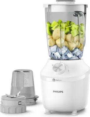 A white Philips blender with a pitcher filled with fruit and ice, along with two accessories.
