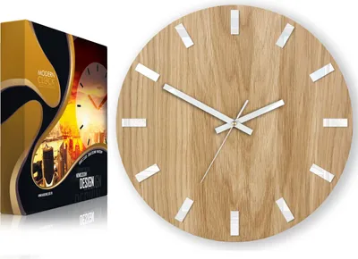 A product shot of a modern wooden clock next to its packaging.