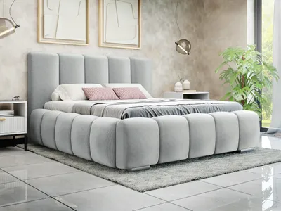 A bedroom scene featuring a modern upholstered bed.