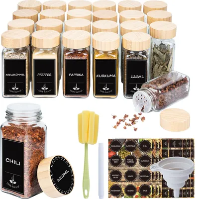 A collection of glass spice jars with wooden lids, labels, a funnel, and a cleaning brush, arranged on a white background.
