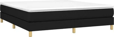 A black boxspring bed frame with a white mattress topper, shown from a side angle on a white background.