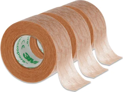 Three rolls of medical tape are shown side-by-side, with the tape unspooling from each roll.