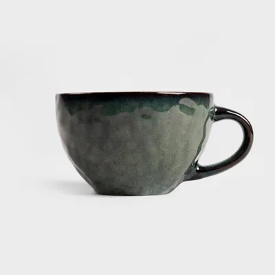 A dark green ceramic mug is shown against a white background.