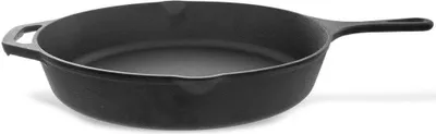 A black cast iron frying pan is shown from a side angle against a white background.