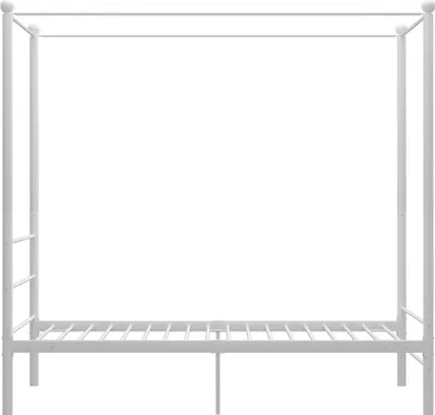 A white metal canopy bed frame.